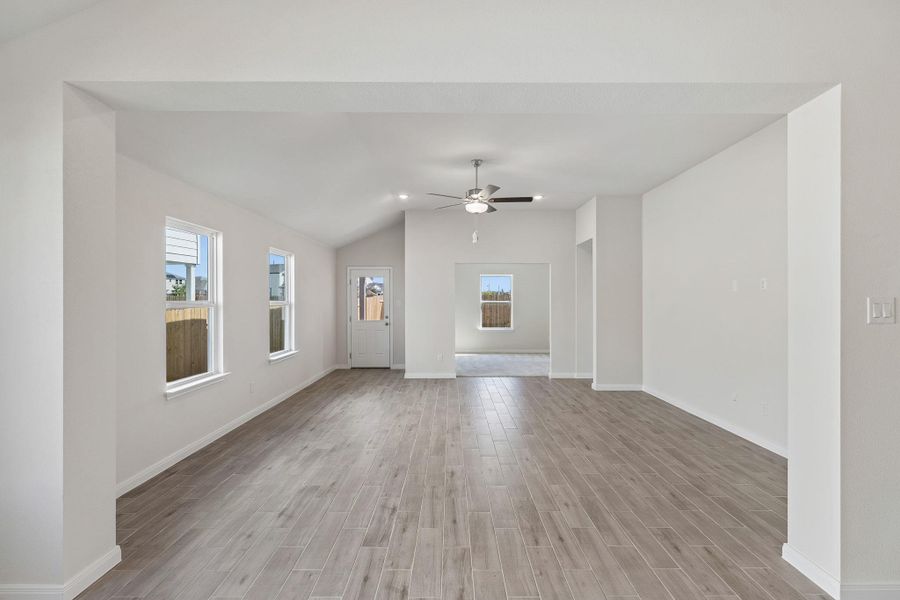An open living space highlights durable wood-look tile flooring and clean neutral finishes.