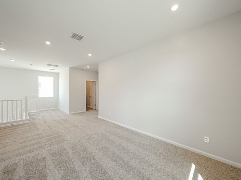 A room with a carpet and a door. A room with a carpet and a door.