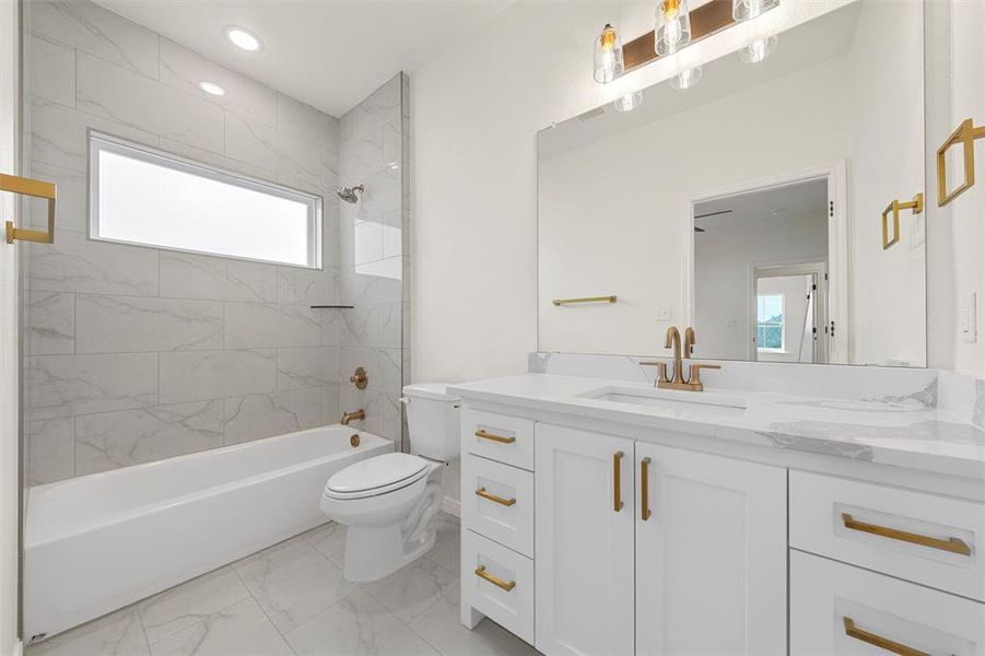 Bathroom with shower combination, vanity, light marble finish flooring, and recessed lighting Bathroom with shower combination, vanity, light marble finish flooring, and recessed lighting