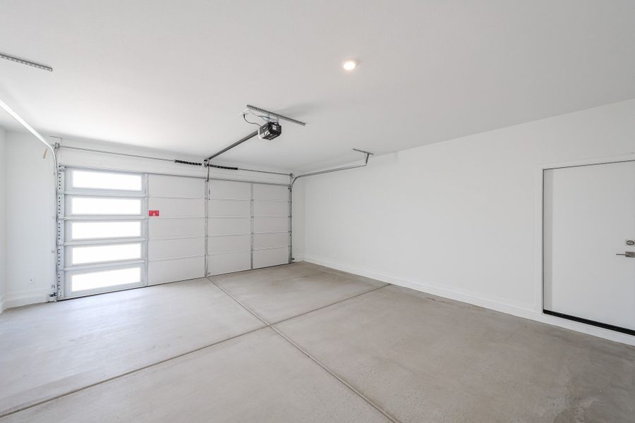 A room with white walls and a ceiling fan.