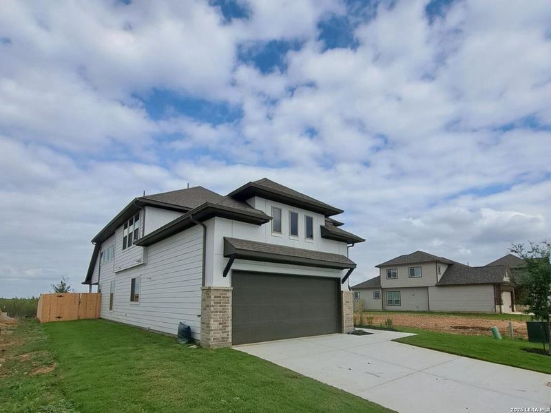 Front exterior of a new home in Rhine Valley, Schertz, TX, highlighting curb appeal (Image 15).