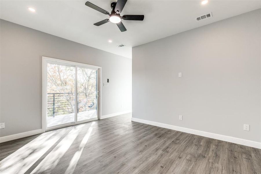 Empty room with dark hardwood / wood-style floors and ceiling fan