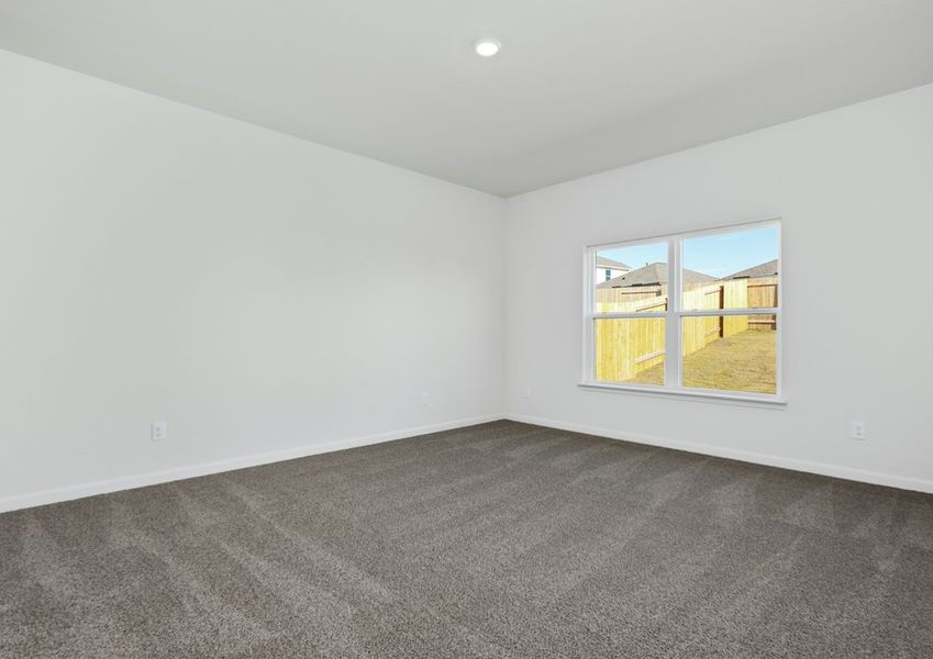 The master bedroom has a large window that lets in natural light.