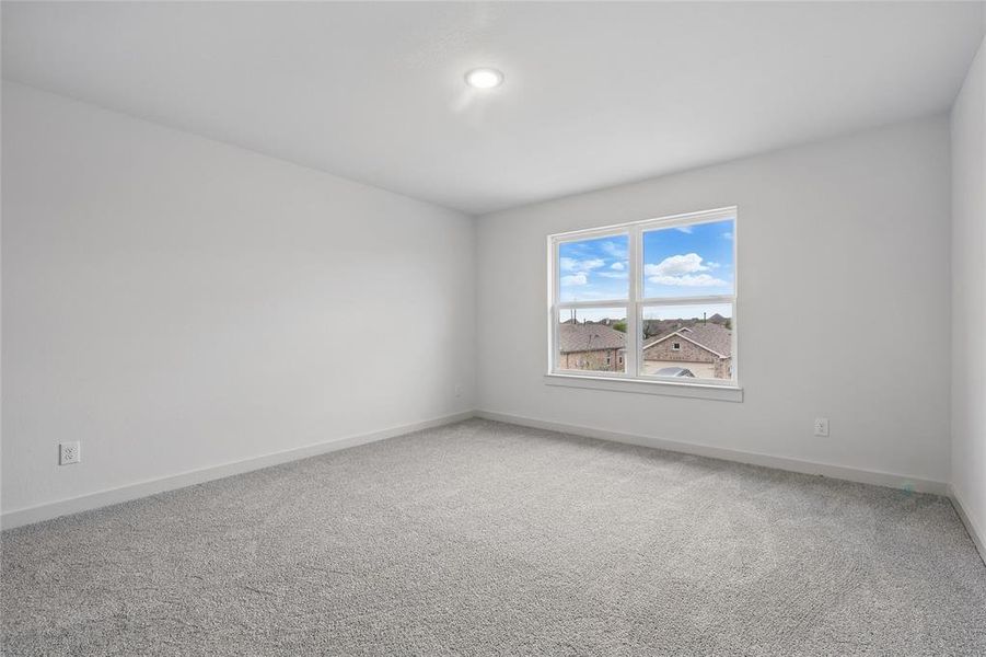 Spare room featuring baseboards and light colored carpet Spare room featuring baseboards and light colored carpet