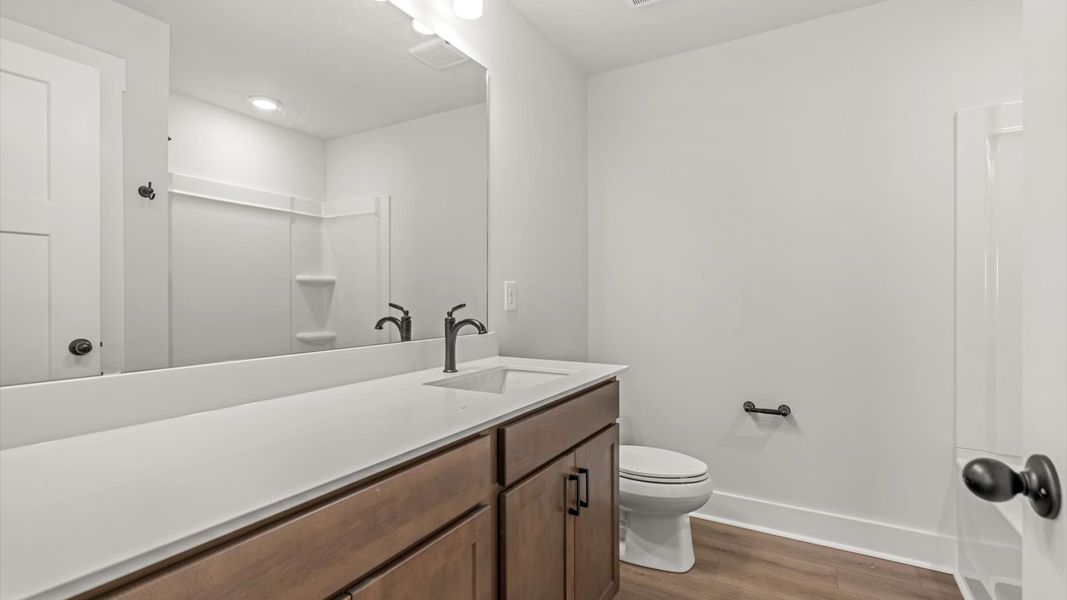 Highly skilled design seen in this polished and practical full bathroom