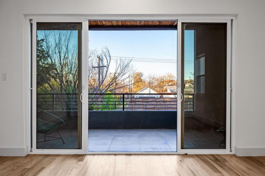 Doorway featuring a wealth of natural light and light hardwood / wood-style flooring