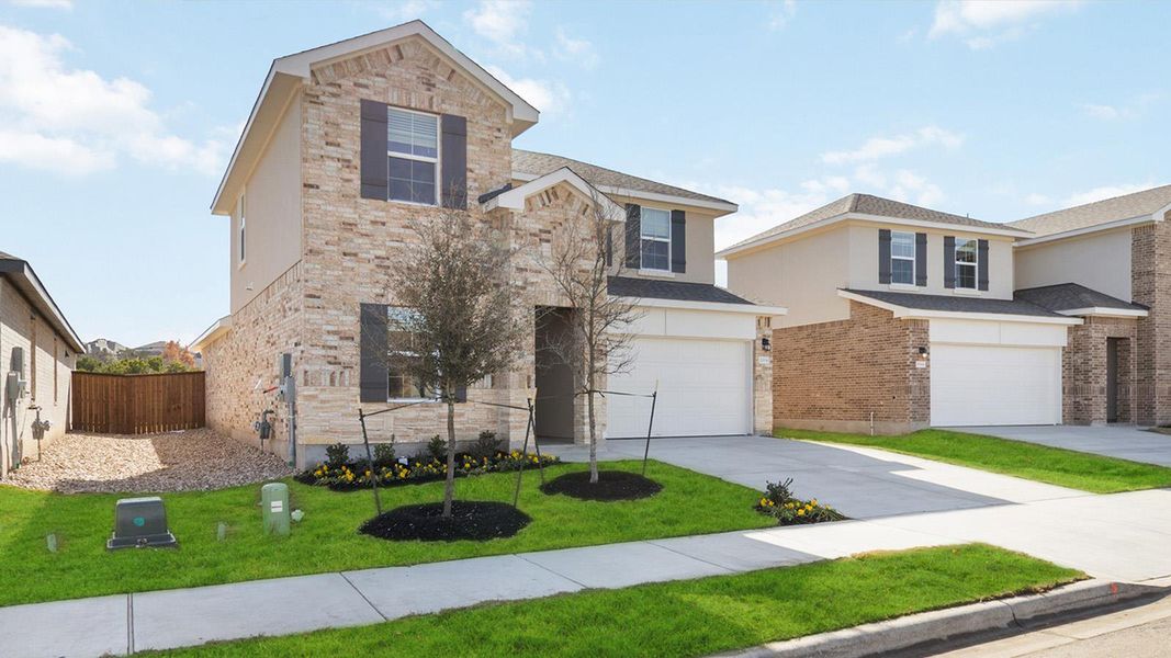 Front exterior of a new home in Bar W Ranch, Leander, TX, highlighting curb appeal (Image 16).
