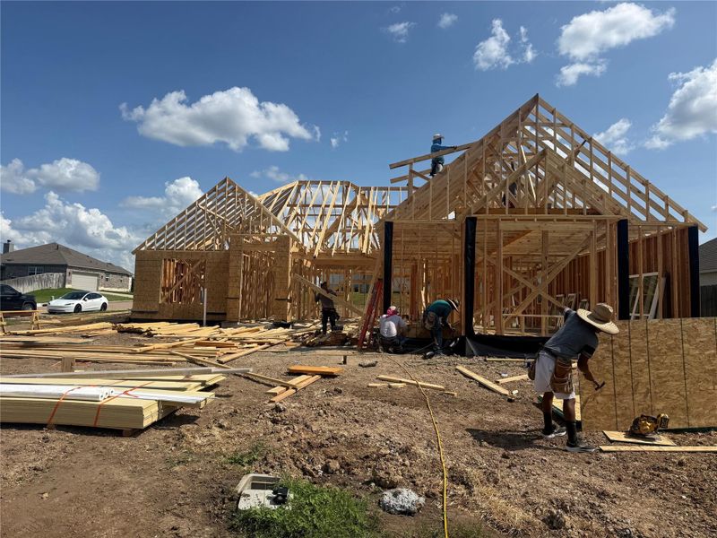 Construction progress at 1707 Twin Oaks Circle, showing framing underway on this new home in Timber Oaks.