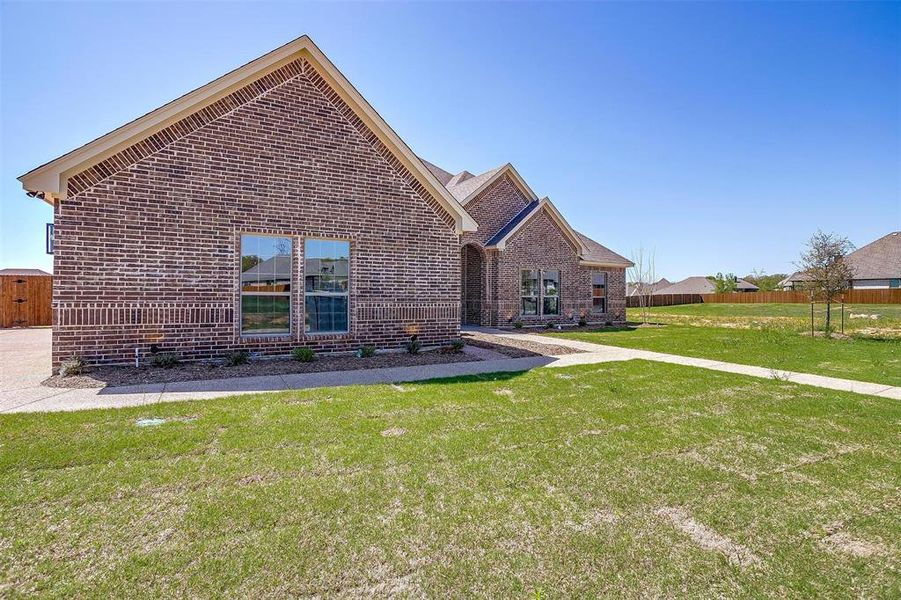 Front exterior of a new home in , Burleson, TX, highlighting curb appeal (Image 25). Front exterior of a new home in , Burleson, TX, highlighting curb appeal (Image 25).
