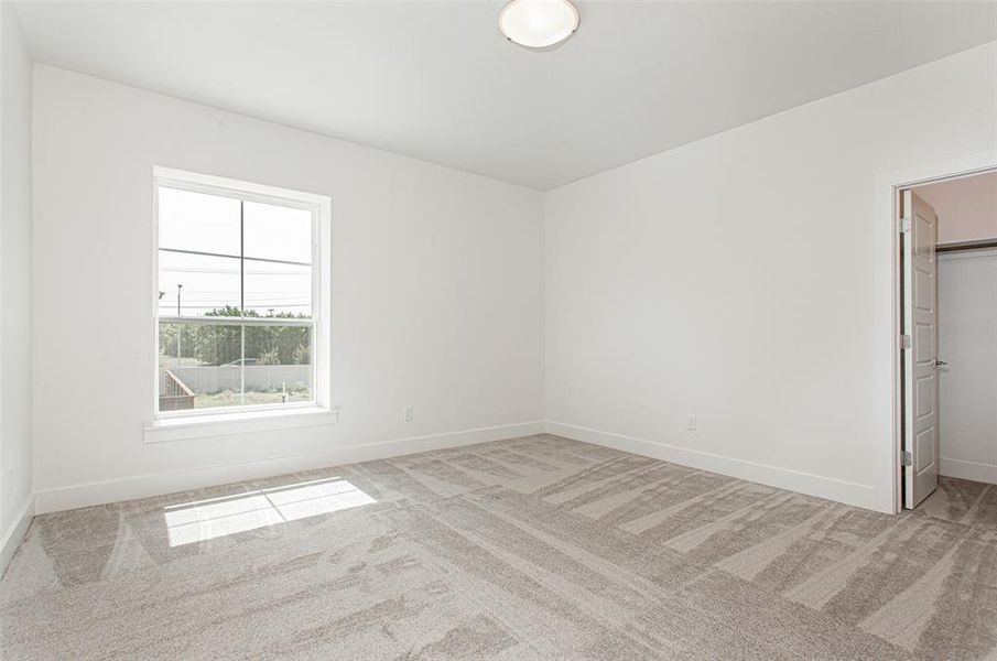 Unfurnished room with light colored carpet