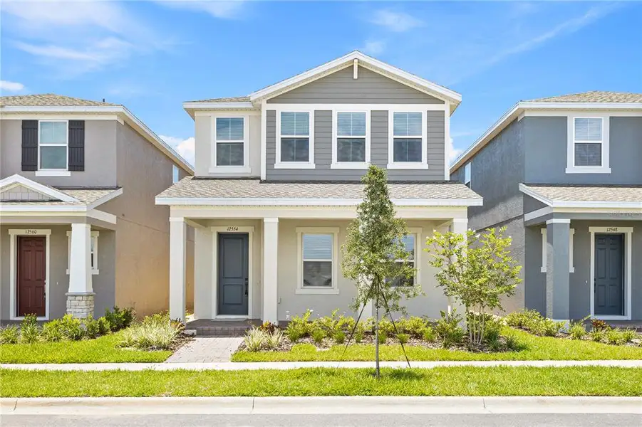 Front exterior of a new home in Osprey Ranch, Winter Garden, FL, highlighting curb appeal (Image 1).