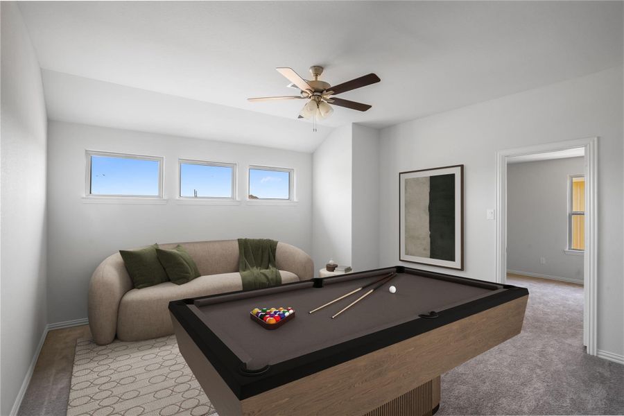Upstairs game room features plush carpet, ceiling fan, and windows for natural light.
