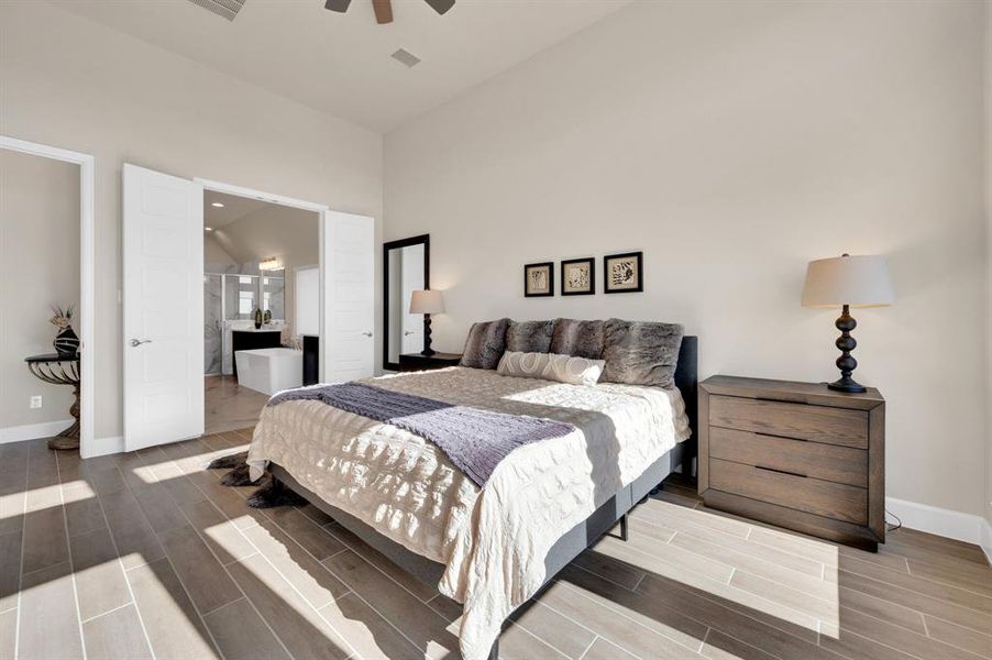 Gorgeous Primary Suite flooded with natural light in this 18' x 13' room with 12'ceilings.