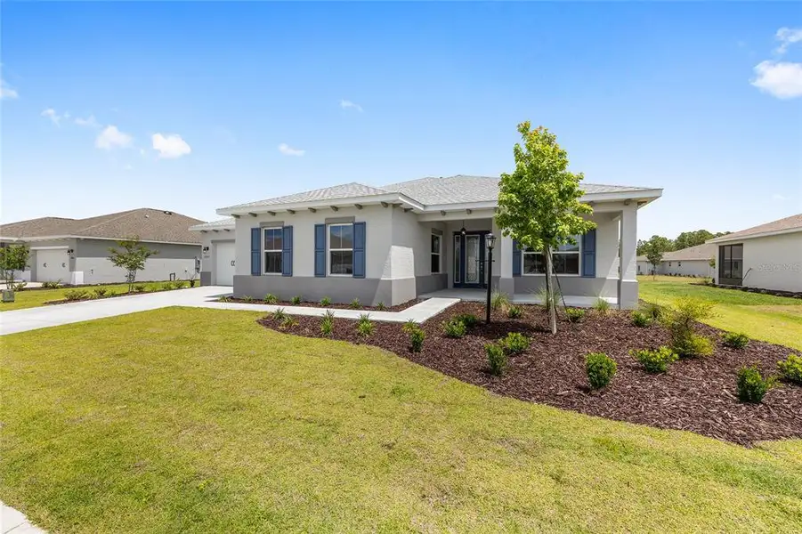 Front exterior of a new home in , Ocala, FL, highlighting curb appeal (Image 2). Front exterior of a new home in , Ocala, FL, highlighting curb appeal (Image 2).