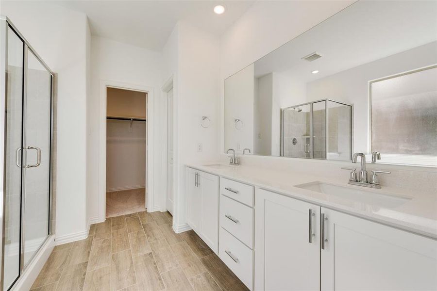 Bathroom with double vanity and walk in shower