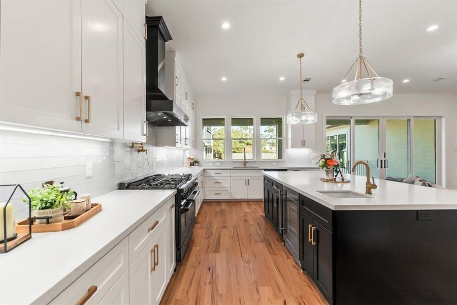 kitchen featuring a spacious island with a prep sink and beverage fridge, sleek quartz countertops, custom soft-close cabinetry, undercabinet lighting, and elegant design throughout.