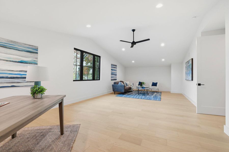 Living area with light wood-style flooring, recessed lighting, a ceiling fan, and vaulted ceiling