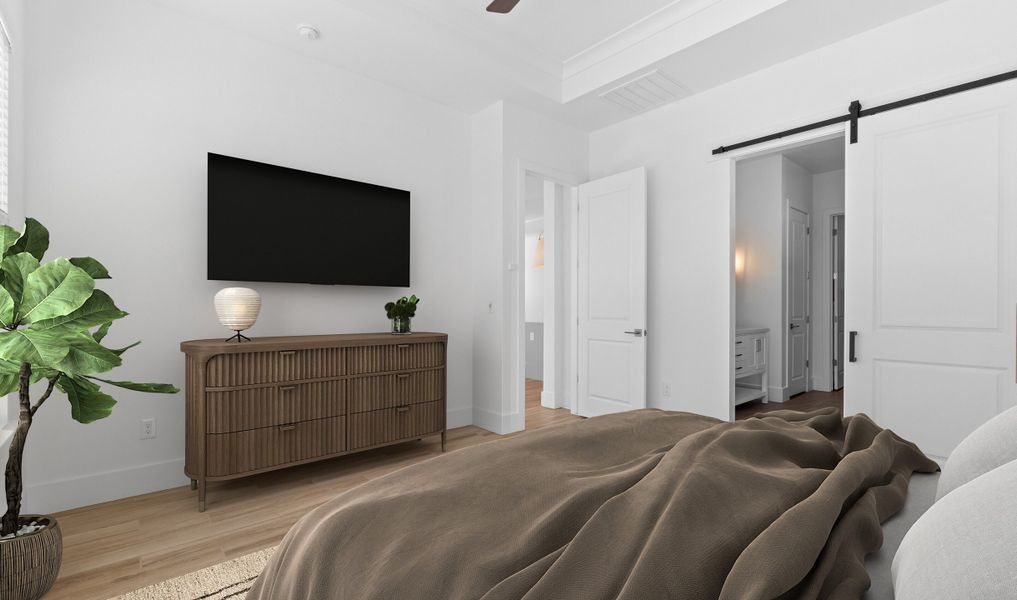 Primary suite with barn door to primary bath