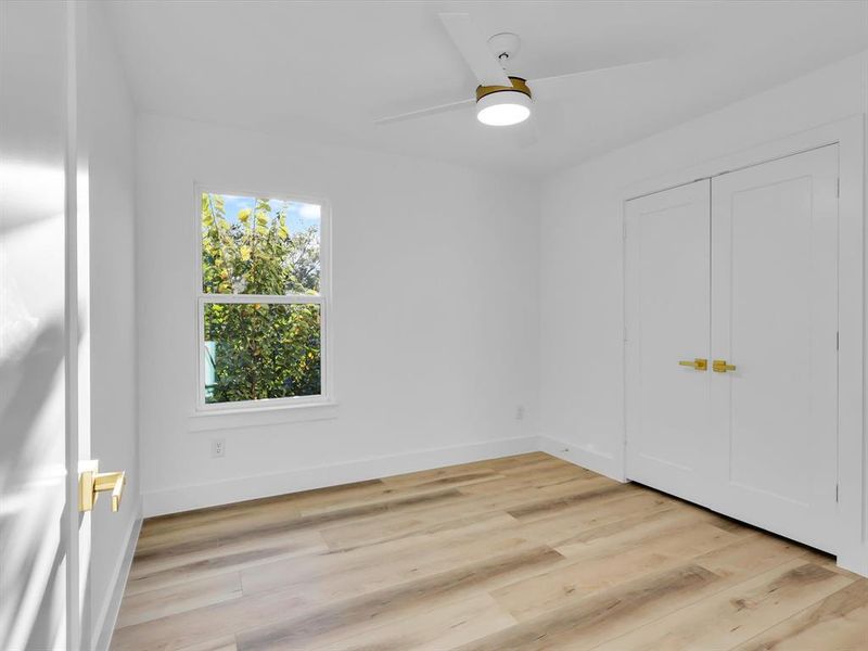 Unfurnished bedroom featuring ceiling fan, a closet, and light hardwood / wood-style floors