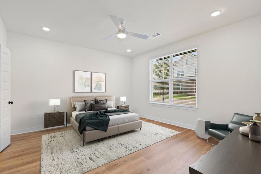 Spacious room featuring wood-finish flooring, recessed lighting, and a modern ceiling fan