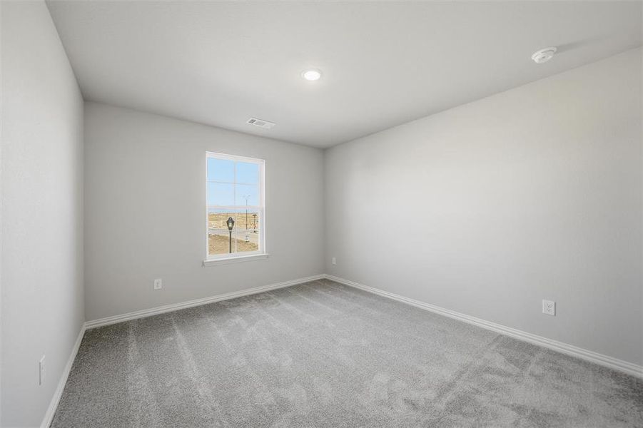 Empty room with light carpet and recessed lighting Empty room with light carpet and recessed lighting