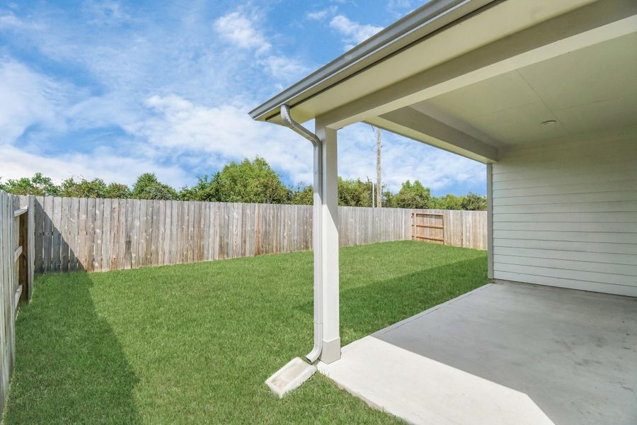 Experience outdoor living at its finest on this expansive covered patio, thoughtfully designed for BBQs and delightful outdoor dining.