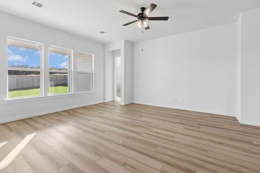 Spare room featuring light wood-style flooring and a ceiling fan