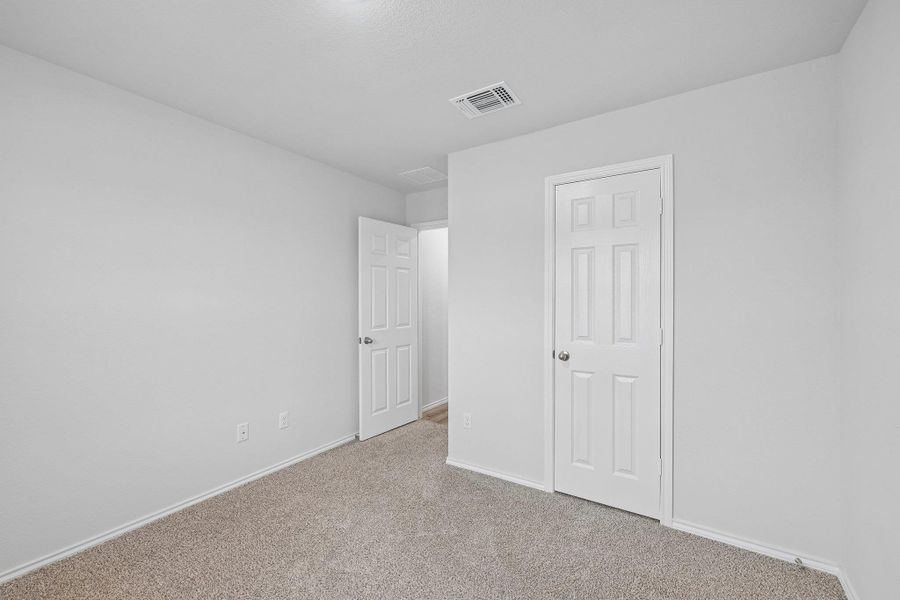 Neutral wall tones with light-toned carpeting and white baseboards