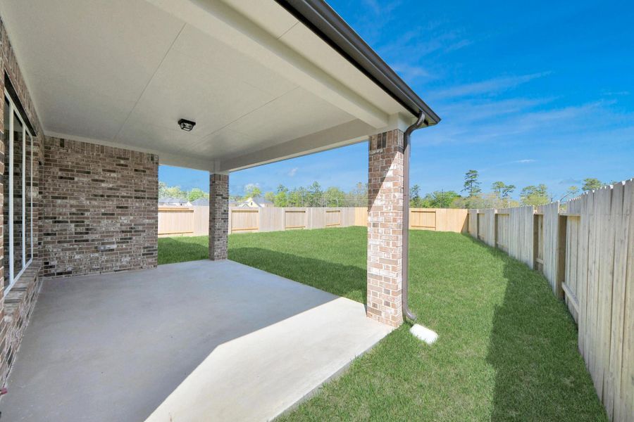 Experience outdoor living at its finest on this expansive covered patio, thoughtfully designed for BBQs and delightful outdoor dining.