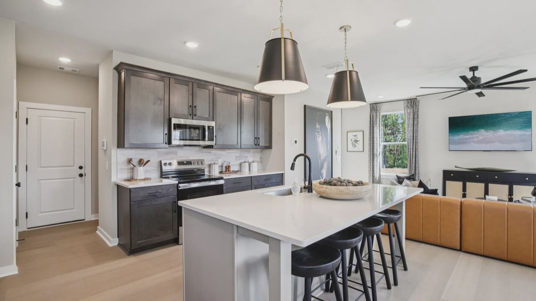 Kitchen with quartz countertops, pendant lighting, and hard-surface flooring