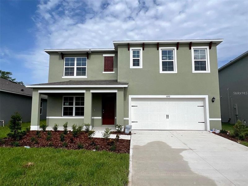 Front exterior of a new home in , Haines City, FL, highlighting curb appeal (Image 1).