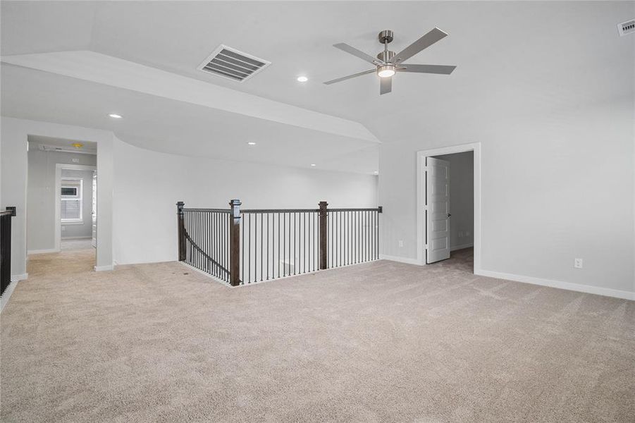 Another view of the Game Room looking to staircase, media room, and second bedrooms.