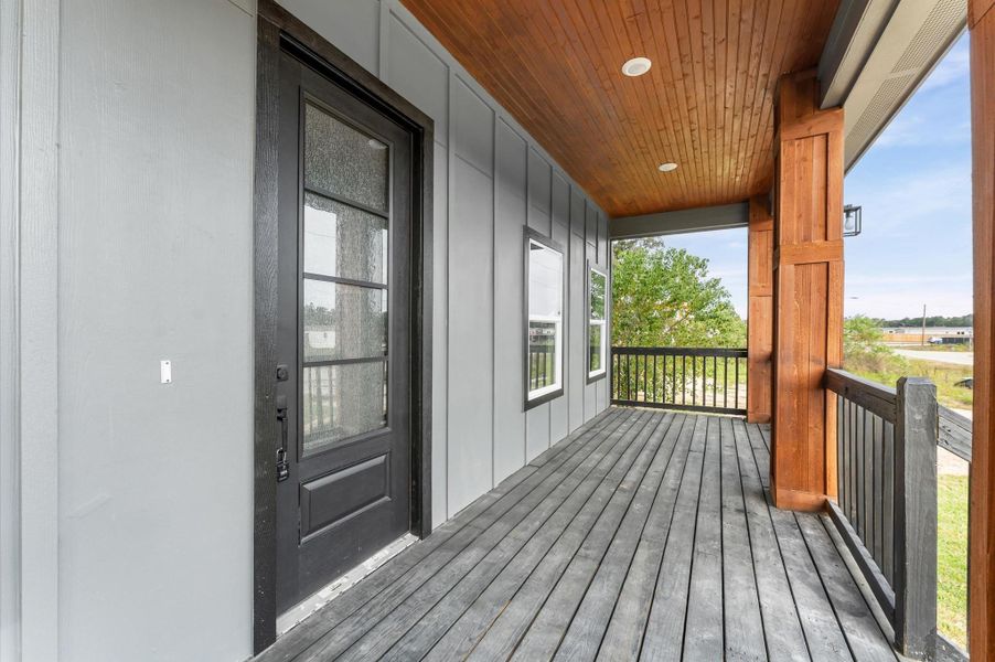 Large covered front porch with wood accents and LED lighting. Large covered front porch with wood accents and LED lighting.