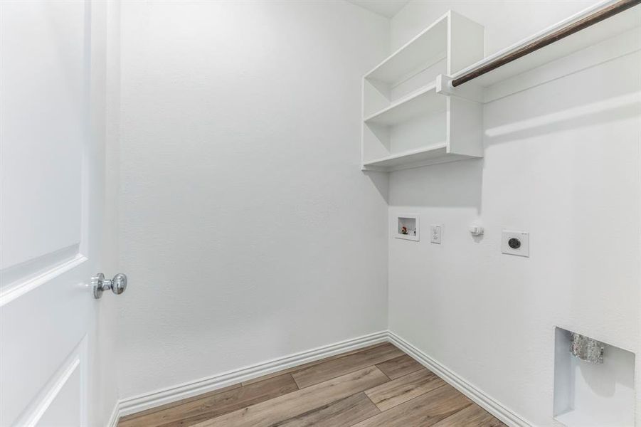 Laundry room with washer hookup, hookup for a gas dryer, hookup for an electric dryer, and light hardwood / wood-style floors