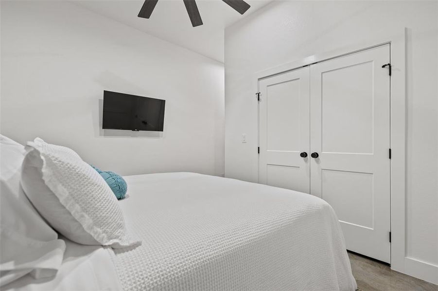 Bedroom featuring ceiling fan and a closet