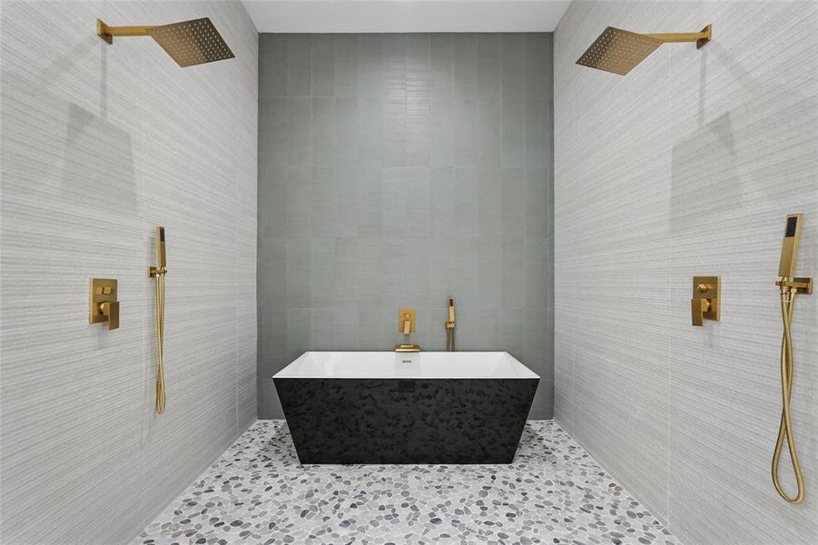 Bathroom featuring tile walls, tiled shower, and tile patterned floors Bathroom featuring tile walls, tiled shower, and tile patterned floors