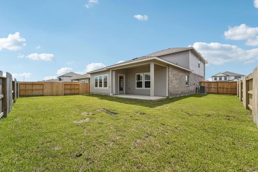 Front exterior of a new home in Heights of Barbers Hill, Mont Belvieu, TX, highlighting curb appeal (Image 1). Front exterior of a new home in Heights of Barbers Hill, Mont Belvieu, TX, highlighting curb appeal (Image 1).