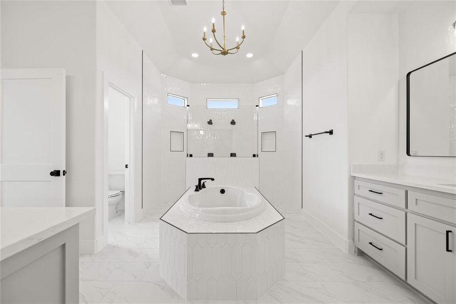 Bathroom featuring vanity, a walk in shower, a garden tub, recessed lighting, and a chandelier Bathroom featuring vanity, a walk in shower, a garden tub, recessed lighting, and a chandelier