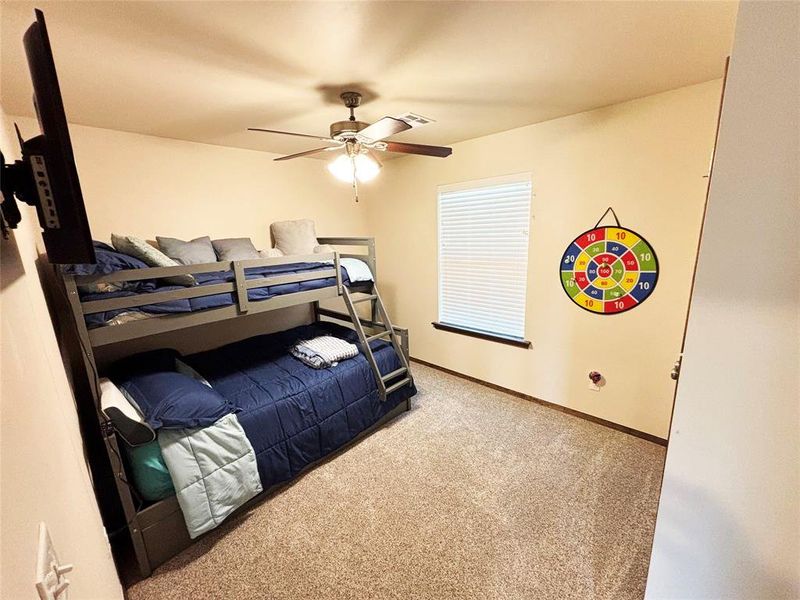 Bedroom featuring light carpet and ceiling fan Bedroom featuring light carpet and ceiling fan