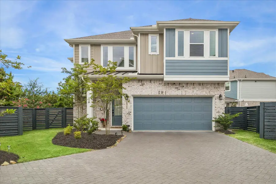 Beautiful curb appeal welcomes you home with a two-car garage, modern fencing, and thoughtfully landscaped flower beds that frame the front of the property.