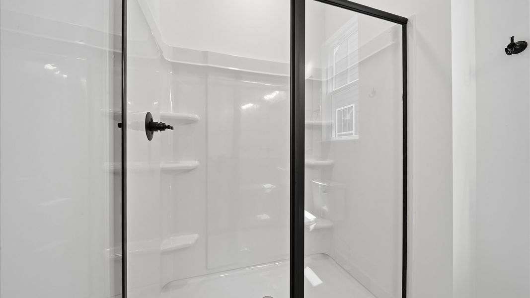 Highly functional and elegant en-suite with dual vanities, walk-in shower, and refined finishes Highly functional and elegant en-suite with dual vanities, walk-in shower, and refined finishes