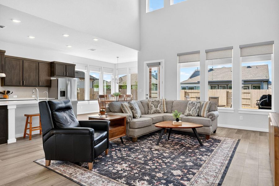 2-story Living room with abundant windows & natural light. Open to the kitchen &  dining room.