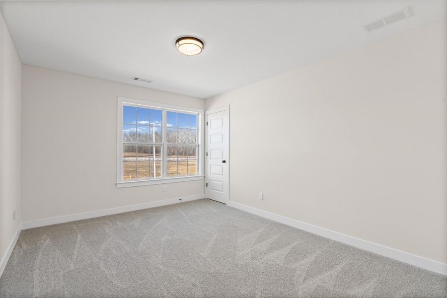 Spare room featuring baseboards and light colored carpet Spare room featuring baseboards and light colored carpet
