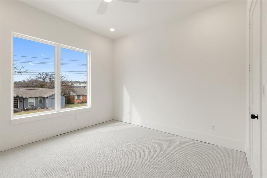 Carpeted bedroom faces the front of the home