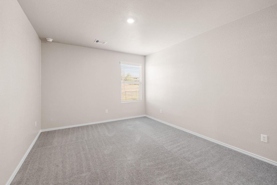 Empty room featuring carpet and baseboards