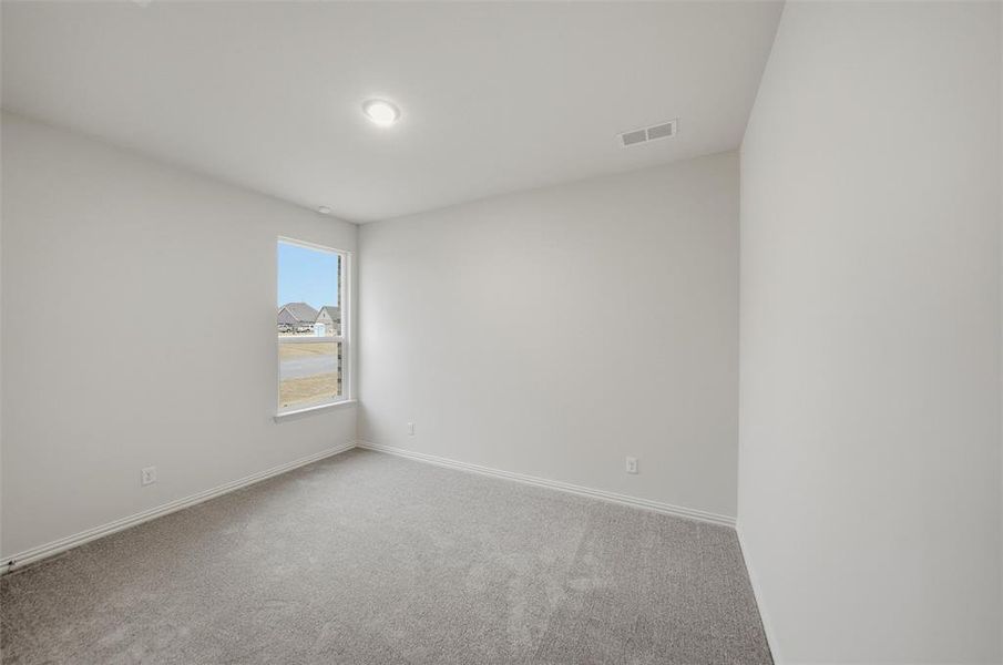 Carpeted empty room featuring baseboards