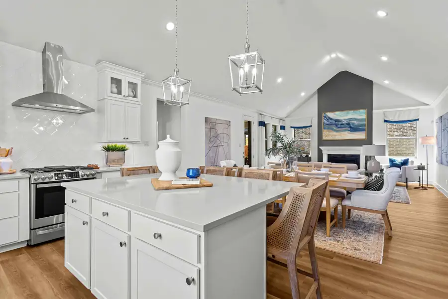 Kitchen with large island adjacent to dining area and great room