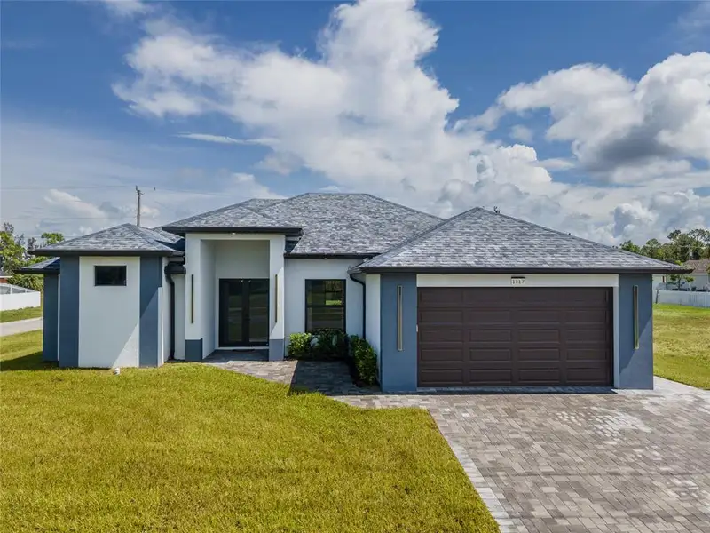 Front exterior of a new home in , Cape Coral, FL, highlighting curb appeal (Image 2). Front exterior of a new home in , Cape Coral, FL, highlighting curb appeal (Image 2).