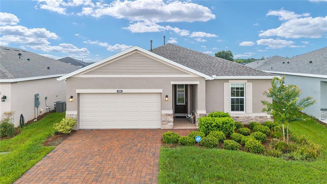 Front exterior of a new home in Ocala Preserve, Ocala, FL, highlighting curb appeal (Image 22).
