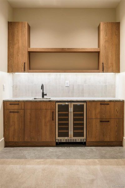 Basement rec room space with a wet bar
